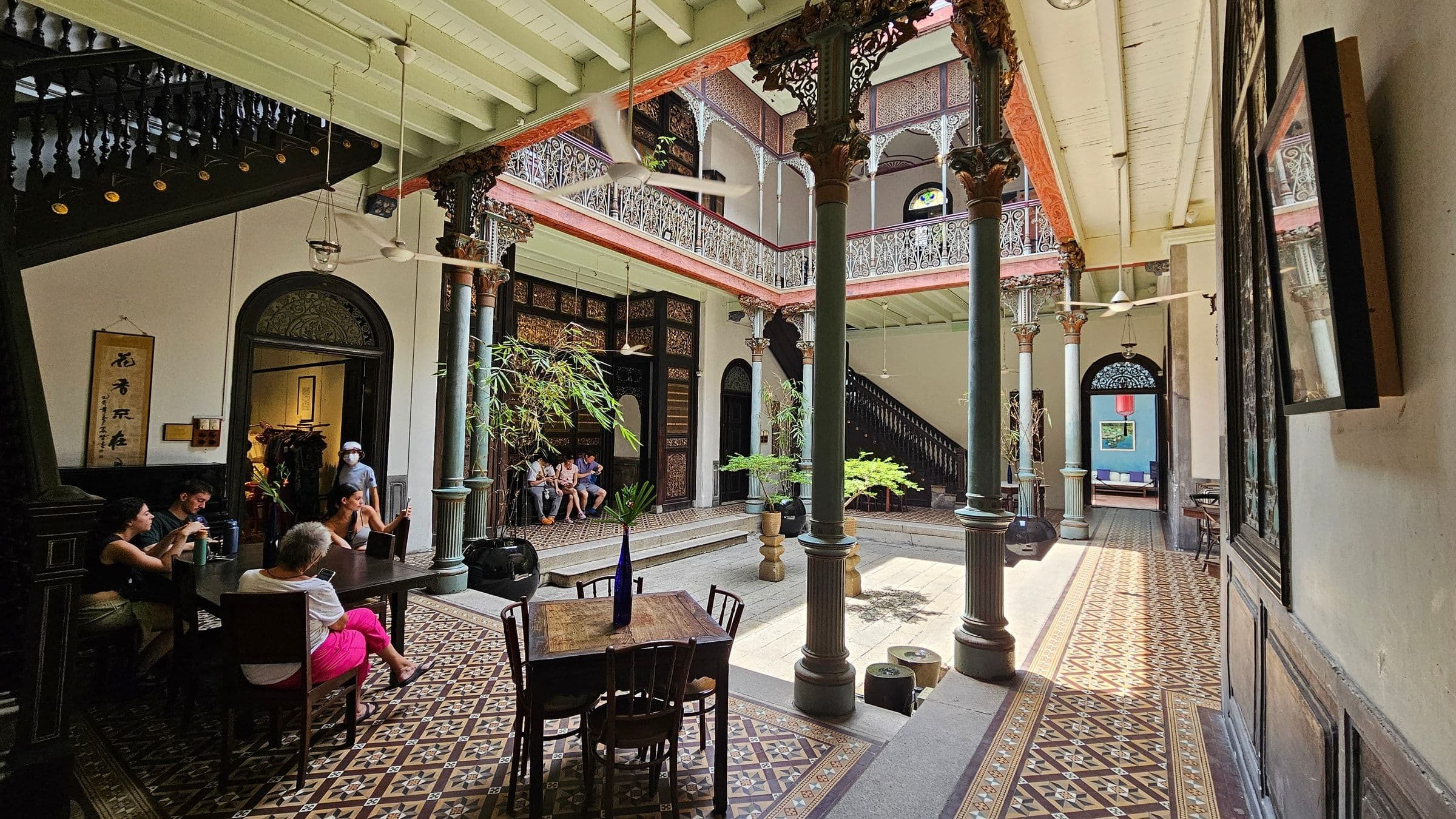The inner courtyard of the Cheong Fatt Tze Mansion with cast-iron balustrades and patterned floor tiles