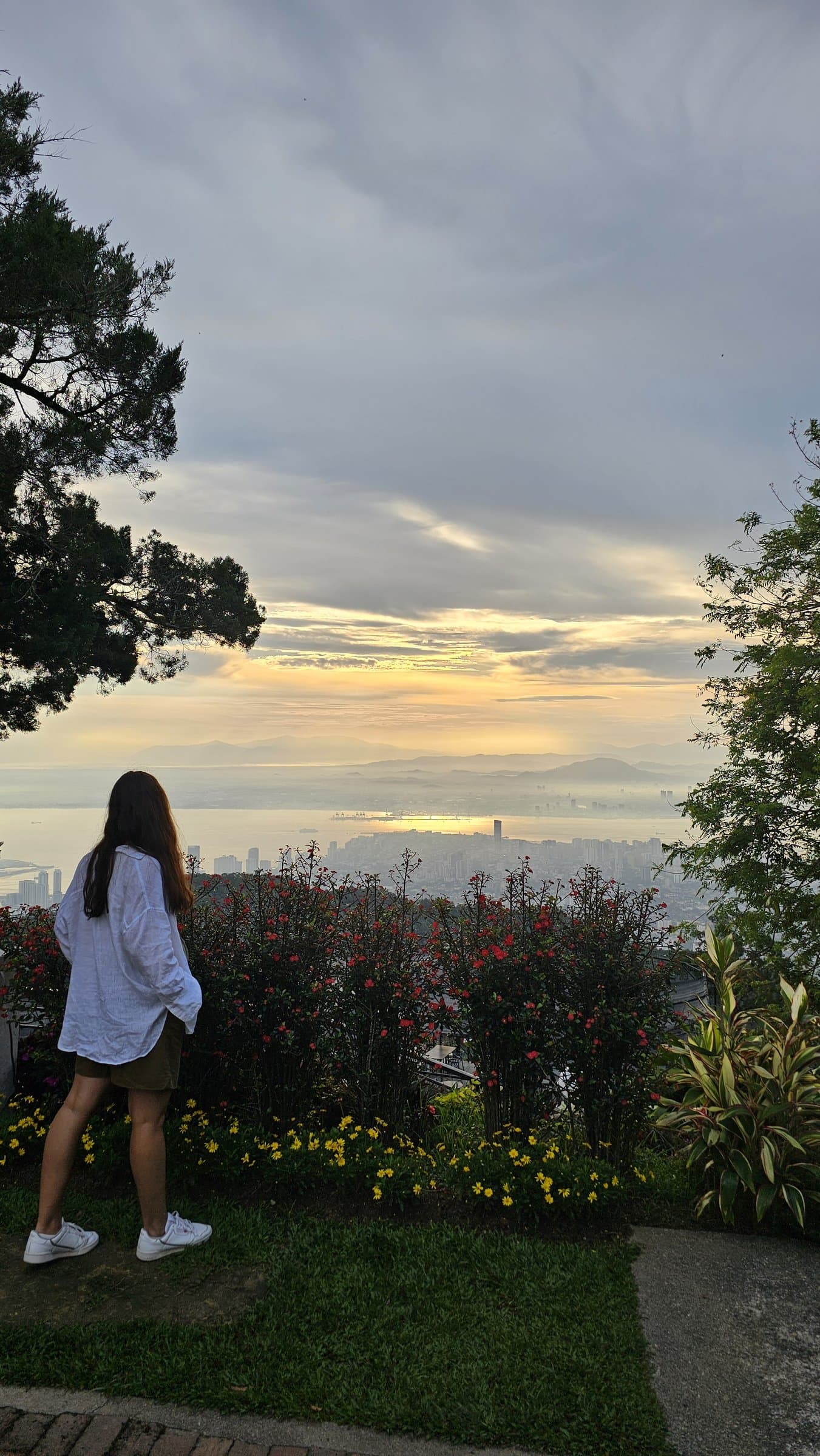 A golden-hour view over George Town and the Strait of Malacca from the summit of Penang Hill