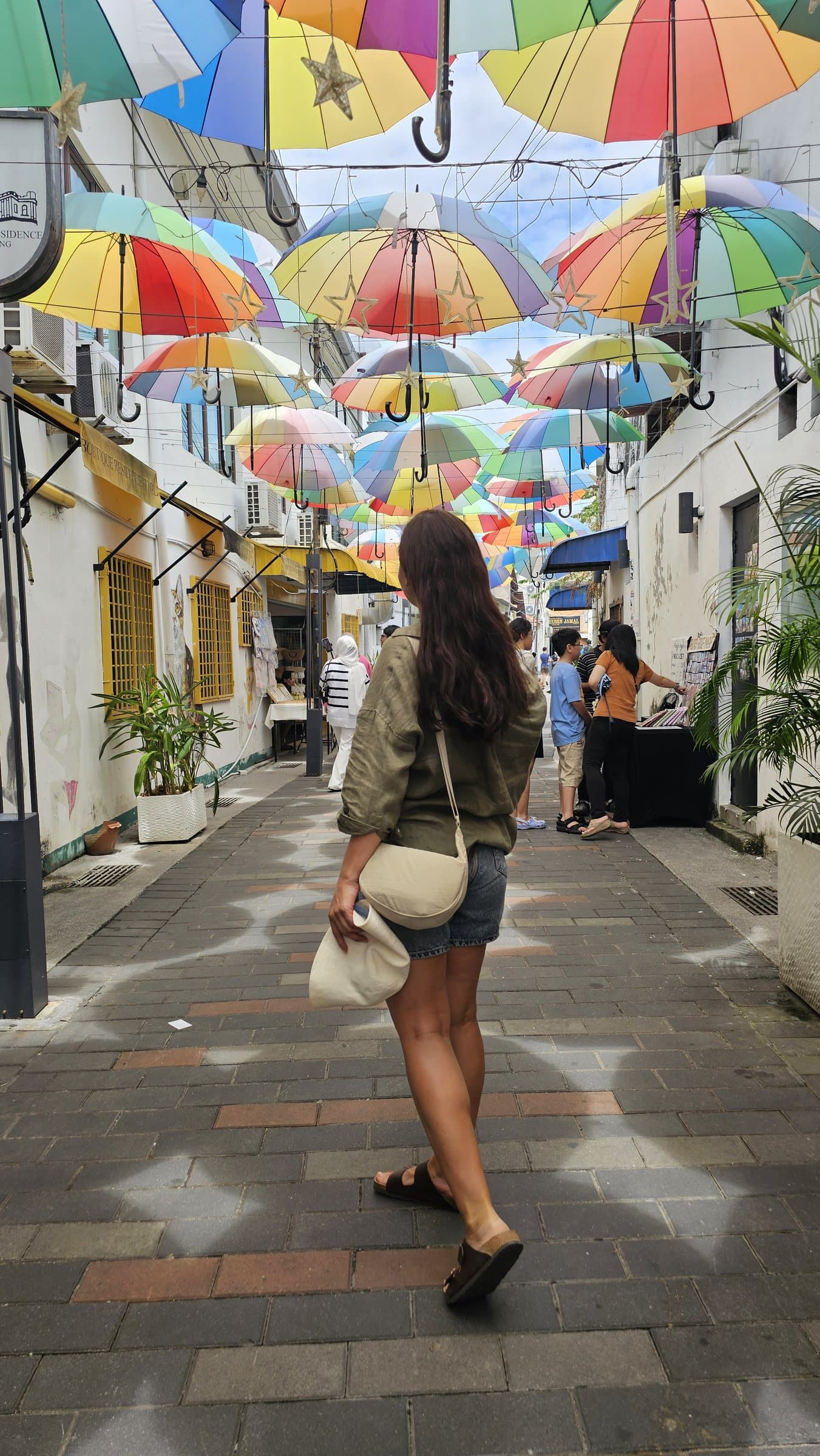 Rows of suspended colourful umbrellas decorating a heritage street art alley in George Town